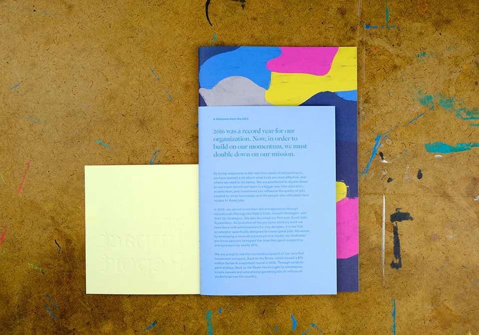2017 Impact Report open-flap spread showing layered paper and print construction.